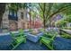 Cozy fire pit area with green chairs surrounded by landscaping and renovated brick buildings at 170 Boulevard Se # E414, Atlanta, GA 30312