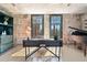 Stylish living space with exposed brick, large windows, built-in shelving, and a grand piano, offering a blend of modern and classic at 170 Boulevard Se # E414, Atlanta, GA 30312