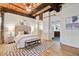 Comfortable main bedroom with high wood ceilings, ensuite access, and patterned rug at 170 Boulevard Se # E414, Atlanta, GA 30312