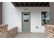 Front entrance of home, featuring a green door, brick accents, and white siding at 2215 Nena Way # 20, Tucker, GA 30084