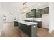 Open kitchen features an island, stainless steel appliances, and custom pendant lighting at 2215 Nena Way # 20, Tucker, GA 30084