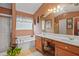 Well-lit bathroom featuring a double sink vanity, bath tub, tiled shower with glass door, and decorative mirror at 238 Diamond Valley Pass, Canton, GA 30114