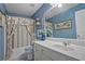 Updated bathroom features blue walls, a white vanity, and a tub shower at 238 Diamond Valley Pass, Canton, GA 30114