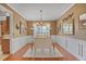 Elegant dining room with wood floors, wainscoting, and a chandelier over the glass table at 238 Diamond Valley Pass, Canton, GA 30114