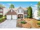 Charming two-story home with brick and siding, a well-manicured front yard, and a two-car garage at 238 Diamond Valley Pass, Canton, GA 30114