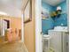 Upstairs hallway with laundry closet, neutral decor, and mirror at 238 Diamond Valley Pass, Canton, GA 30114