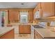 Functional kitchen with wooden cabinets, white countertops, and modern appliances at 238 Diamond Valley Pass, Canton, GA 30114