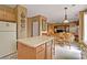 Open kitchen with a central island, wooden cabinets, and a view into the breakfast and living areas at 238 Diamond Valley Pass, Canton, GA 30114