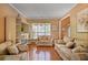 Cozy living room featuring hardwood floors, neutral walls, and comfortable, patterned sofas at 238 Diamond Valley Pass, Canton, GA 30114