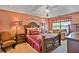 Comfortable main bedroom featuring a sitting area, ceiling fan and a large bed with matching furniture at 238 Diamond Valley Pass, Canton, GA 30114