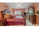 Comfortable main bedroom featuring a sitting area, large bed with matching furniture, and ceiling fan at 238 Diamond Valley Pass, Canton, GA 30114