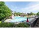 Aerial view of community pool featuring lounge chairs, umbrellas, and nearby clubhouse at 238 Diamond Valley Pass, Canton, GA 30114