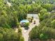 Aerial view of the community pool and tennis courts surrounded by lush trees at 345 Varenna Ln, Sugar Hill, GA 30518