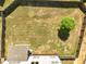 Aerial view of a large backyard with a tree, surrounded by a wooden fence for privacy at 345 Varenna Ln, Sugar Hill, GA 30518