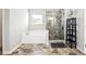 Bathroom featuring a modern glass shower, a soaking tub, and stylish shelving at 345 Varenna Ln, Sugar Hill, GA 30518