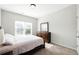 Cozy bedroom featuring neutral tones, a large window, and a wooden dresser at 345 Varenna Ln, Sugar Hill, GA 30518
