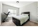 Cozy bedroom with a Queen bed, carpet, and natural light at 345 Varenna Ln, Sugar Hill, GA 30518