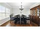 Elegant dining room with hardwood floors, chandelier, and a large china cabinet at 345 Varenna Ln, Sugar Hill, GA 30518