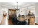 Open-concept dining room with hardwood floors, chandelier, and seamless transition to living areas at 345 Varenna Ln, Sugar Hill, GA 30518