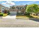 Charming two-story home with brick and stone facade and well-manicured front lawn at 345 Varenna Ln, Sugar Hill, GA 30518
