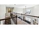 Second story hall showing railing and living room below at 345 Varenna Ln, Sugar Hill, GA 30518