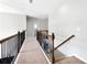 Carpeted hallway with wrought iron railing at 345 Varenna Ln, Sugar Hill, GA 30518