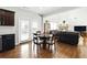 Bright breakfast nook area next to kitchen with views of the open living room, fireplace, and backyard at 345 Varenna Ln, Sugar Hill, GA 30518