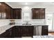 Gourmet kitchen showcasing granite countertops, stainless steel appliances, and dark wood cabinets at 345 Varenna Ln, Sugar Hill, GA 30518