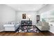 Cozy living room with hardwood floors, comfortable seating, and ample natural light at 345 Varenna Ln, Sugar Hill, GA 30518