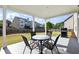Covered patio area with outdoor dining set, barbecue grill, and view of the backyard at 345 Varenna Ln, Sugar Hill, GA 30518