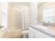 Bathroom featuring a shower-tub combo, modern vanity with a large mirror, and natural light from the window at 555 Letchas Ln, Alpharetta, GA 30009