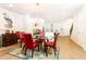 Dining room with glass table and red chairs in an open concept living space at 555 Letchas Ln, Alpharetta, GA 30009