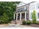 Beautiful two-story home showcasing brick and white siding with black shutters and inviting front porch at 555 Letchas Ln, Alpharetta, GA 30009