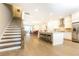 Bright, open kitchen with white cabinets, granite countertops, stainless steel appliances, and wood floors at 555 Letchas Ln, Alpharetta, GA 30009