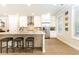 Bright, spacious kitchen with a center island, white cabinets, stainless steel appliances, and natural light at 555 Letchas Ln, Alpharetta, GA 30009