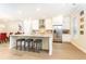 Stylish kitchen featuring a large island with bar seating, modern appliances, and a herringbone backsplash at 555 Letchas Ln, Alpharetta, GA 30009