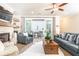 Living room with fireplace, floating shelves, and access to the outdoor patio at 555 Letchas Ln, Alpharetta, GA 30009