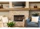 Comfortable living room with a fireplace, wooden mantel, and cozy seating area at 555 Letchas Ln, Alpharetta, GA 30009