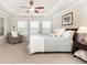 Spacious bedroom with tray ceiling, carpet, ceiling fan, and sunny windows at 555 Letchas Ln, Alpharetta, GA 30009