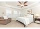 Spacious bedroom with tray ceiling, carpet, ceiling fan, and sunny windows at 555 Letchas Ln, Alpharetta, GA 30009