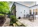 Charming outdoor patio with brick pavers, table and chairs, with landscaping at 555 Letchas Ln, Alpharetta, GA 30009