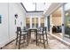 Covered patio with table and chairs, seamlessly connected to the home's indoor living space at 555 Letchas Ln, Alpharetta, GA 30009