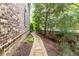 Charming brick home with a stone paver walkway, landscaping and mature trees at 555 Letchas Ln, Alpharetta, GA 30009