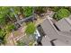Aerial view of a large backyard with patio seating, landscaping, and a charming bridge feature near the house at 5885 Wild Azalea Cv, Sugar Hill, GA 30518