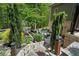 Stone steps lead to a backyard patio surrounded by lush landscaping and mature trees at 5885 Wild Azalea Cv, Sugar Hill, GA 30518