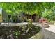 Scenic backyard with patio, outdoor seating, stone landscape, and lush greenery in a serene setting at 5885 Wild Azalea Cv, Sugar Hill, GA 30518