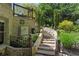 Picturesque backyard features a decorative waterfall and landscaped stone steps to an upper tier at 5885 Wild Azalea Cv, Sugar Hill, GA 30518