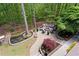 Scenic backyard with a fire pit and seating area nestled among mature trees at 5885 Wild Azalea Cv, Sugar Hill, GA 30518