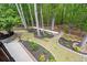 Well-manicured backyard featuring lush landscaping, walking paths, and a bocce ball court at 5885 Wild Azalea Cv, Sugar Hill, GA 30518