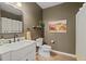 Neutral bathroom featuring a single sink vanity, mirror, and a shower/tub combo at 5885 Wild Azalea Cv, Sugar Hill, GA 30518
